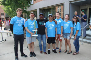 The Applied Linguistics team and Dean Lang take a photo with the fundraising trophy.